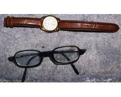 丸型腕時計、眼鏡（黒縁）の写真