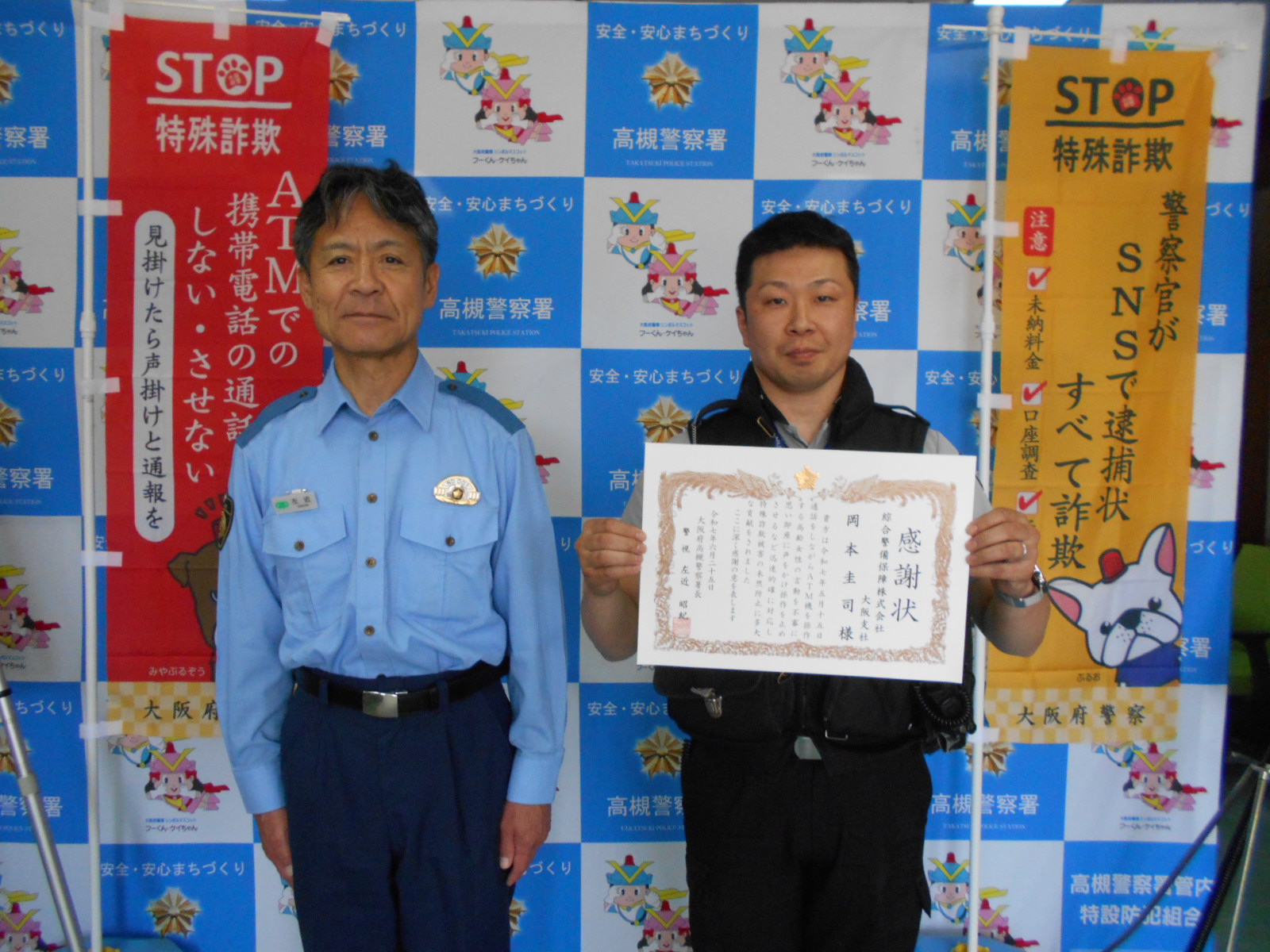 綜合警備保障株式会社従業員が感謝状を一緒に持ち、高槻警察署長と横1列に並んでいる写真